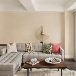 Interior of apartment living room with modern couch and coffee table.