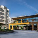 Exterior of modern apartment complex with traffic circle in foreground