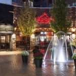 Exterior of restaurant with lit fountain in foreground
