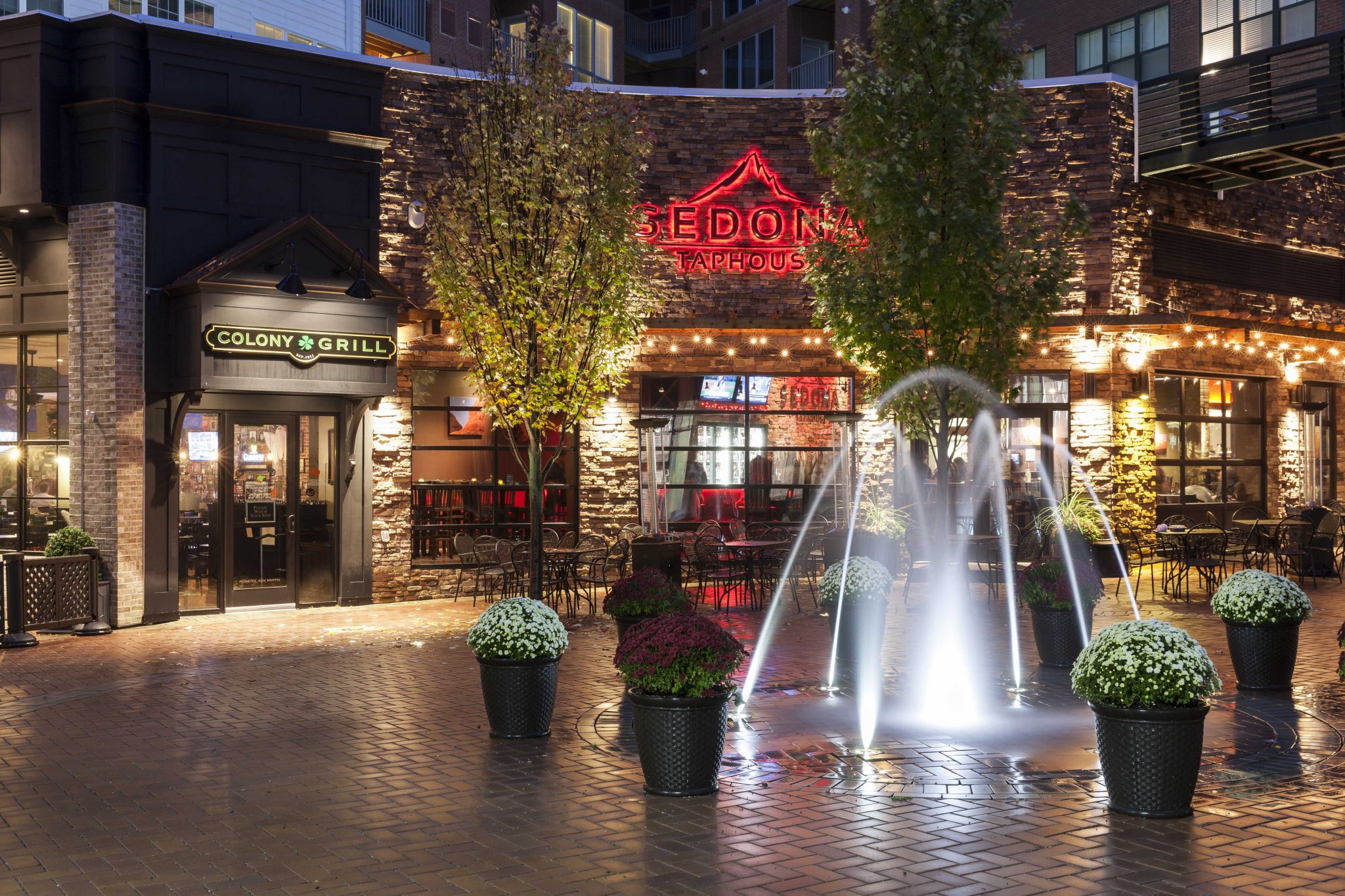 Exterior of restaurant with lit fountain in foreground