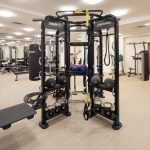 Interior of fitness center with free weights and other exercise machines.