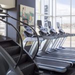 Interior of fitness center with treadmills and stair climbing machines.