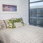 Interior of bedroom featuring large windows.