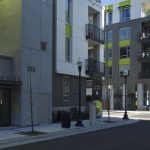 View of the apartment complex entrance and street corner.