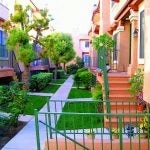 View of the walkway between two buildings and staircases to the entrances of the units.