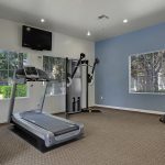 Fitness center with various exercise equipment.