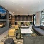 Interior of common area with couch, chairs and fireplace