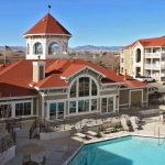 View of the apartment complex with pool in the foreground.
