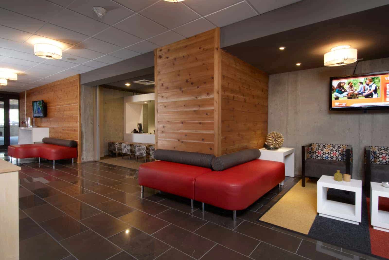 Lobby area with chairs, side tables and bench seating.