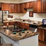 Interior of kitchen with stainless steel appliances and island.