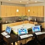 Common area kitchen with laptops on a counter in the foreground.