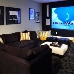 Theatre room with couches, and ottomans.