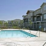 View of the pool area with the apartment buildings in the background.