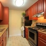 Galley kitchen with stainless steel appliances.