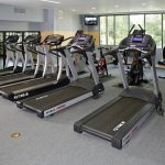 Fitness center with cardio equipment.
