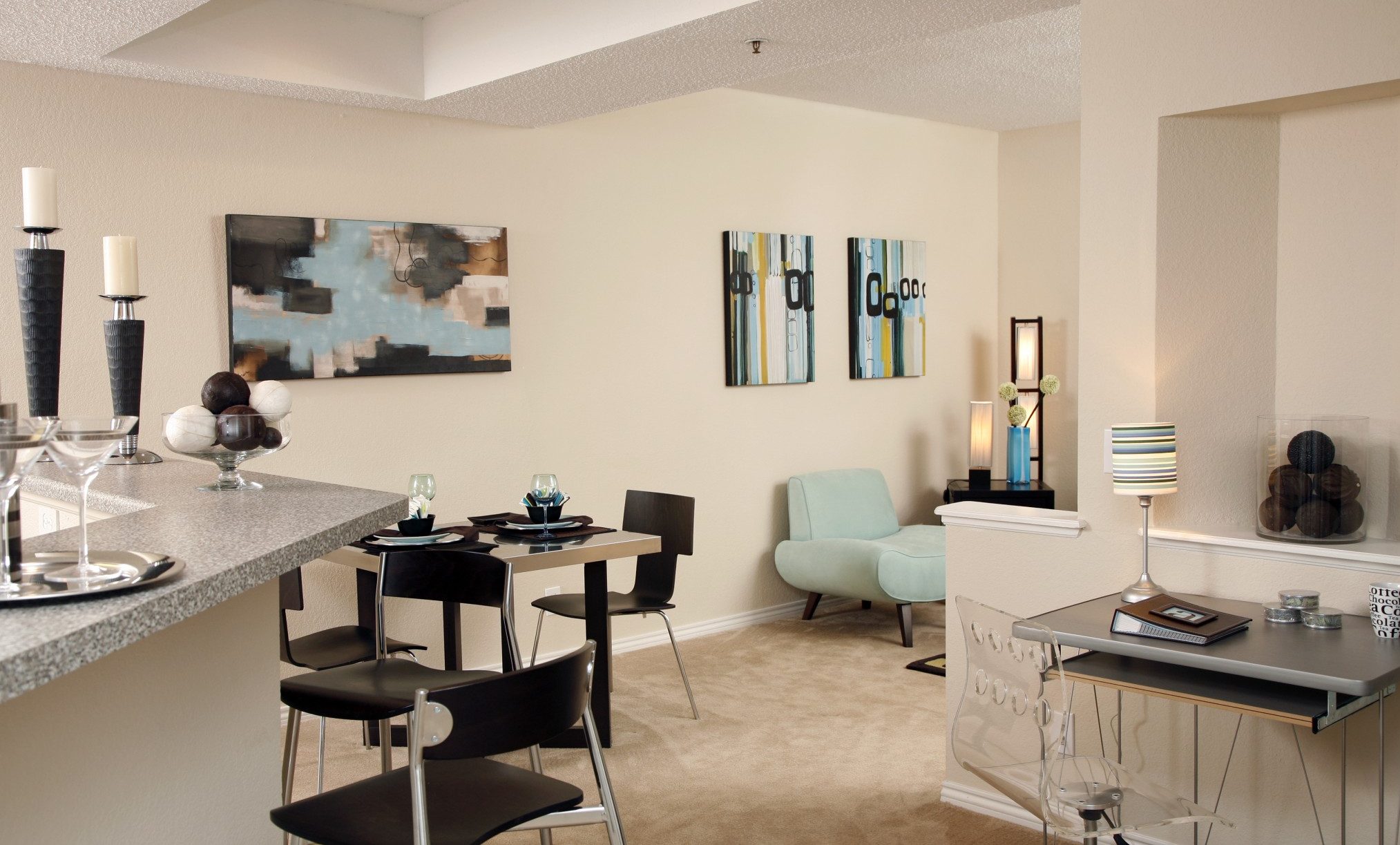 Interior of apartment showing corner of the kitchen counter and dining area.
