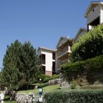 Upward view of apartment buildings and landscaping.