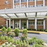 Entrance to building with a flower bed in the foreground.