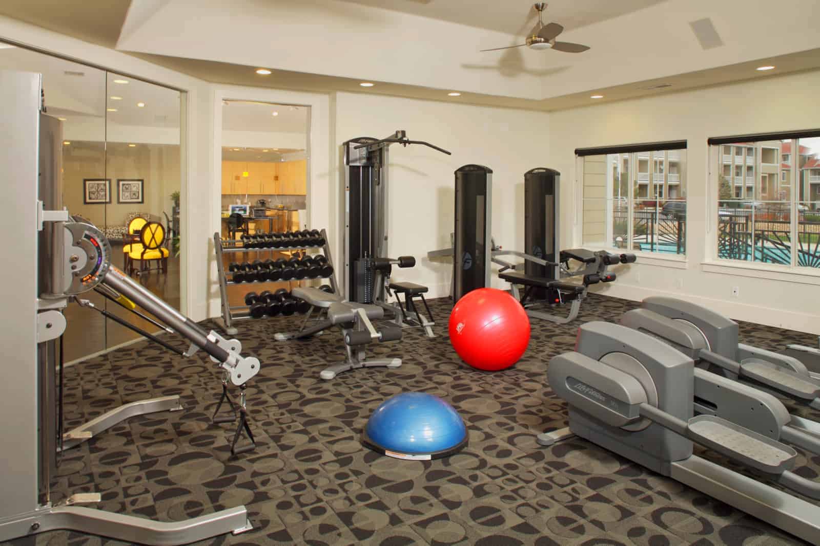 Fitness center with various exercise equipment.