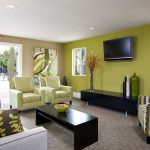 Interior of clubhouse with couch, chairs, coffee table, and TV.