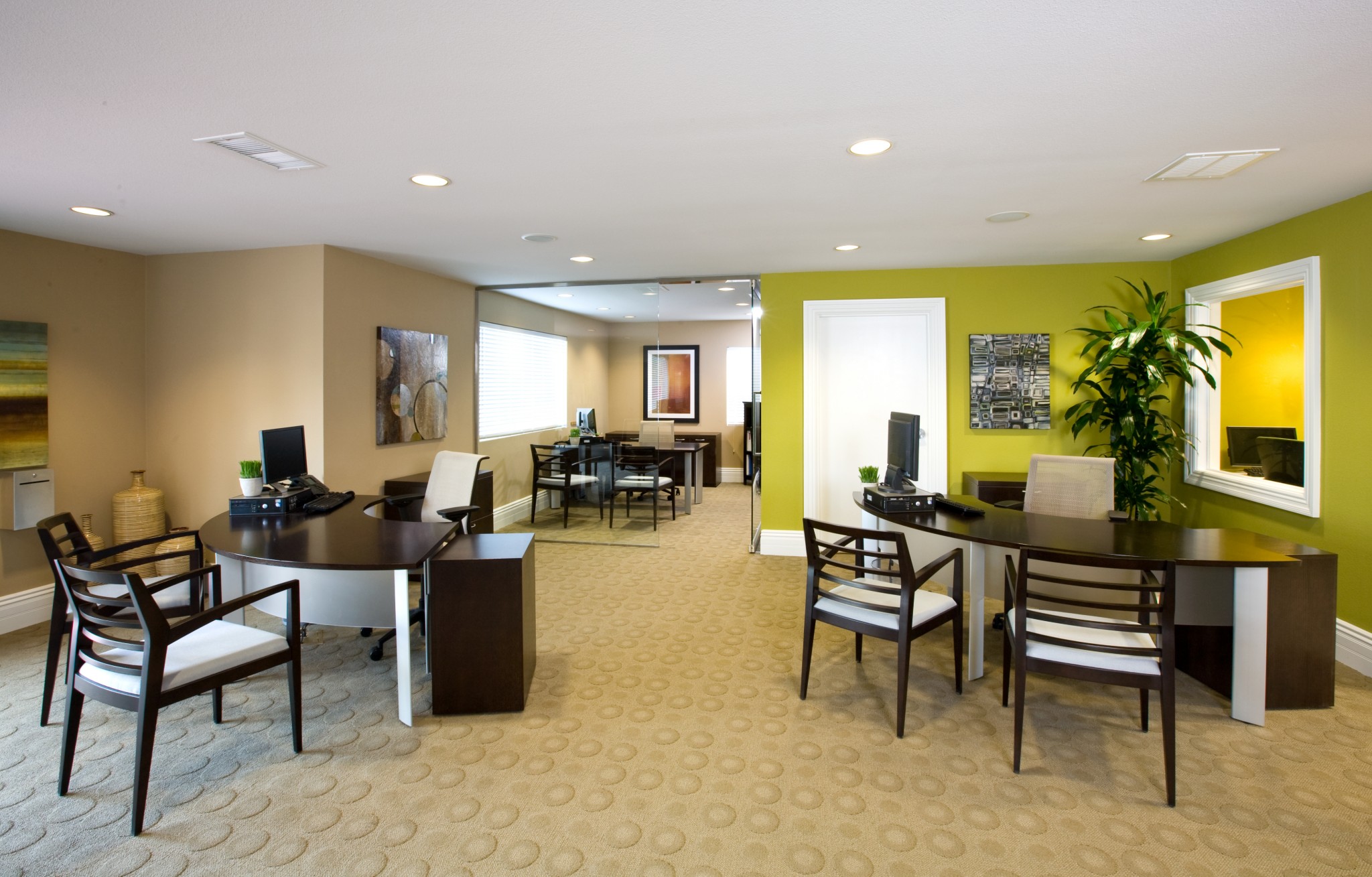 Apartment office with several desks and chairs set up.