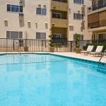 Close up of courtyard pool and apartment building in the background.