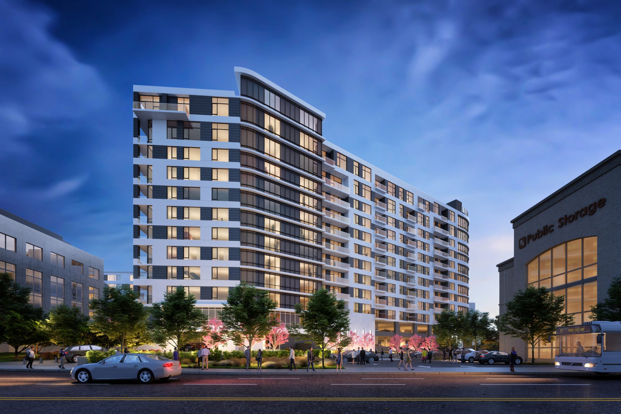 Exterior of 11-story modern apartment building with roadway in foreground