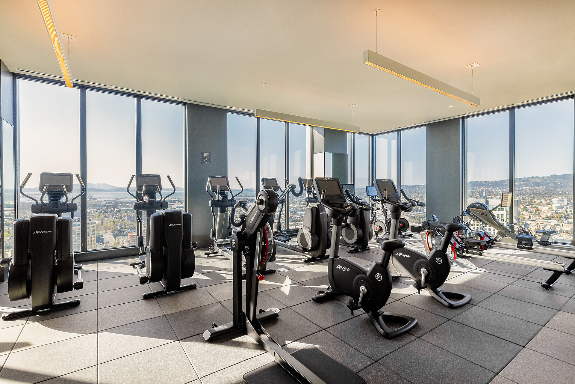 Interior gym with floor to ceiling windows and exercise machines