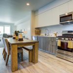 Modern interior of open kitchen, dining table and living room