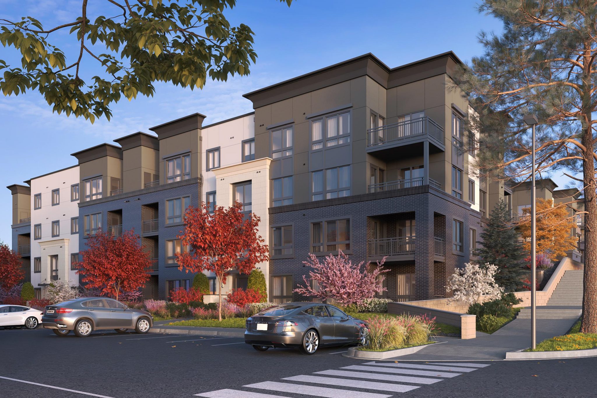 Exterior of 4-story apartment building with parking lot, cross walk and concrete stairs in foreground