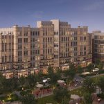Wide exterior of entire apartment building with park-like setting in foreground