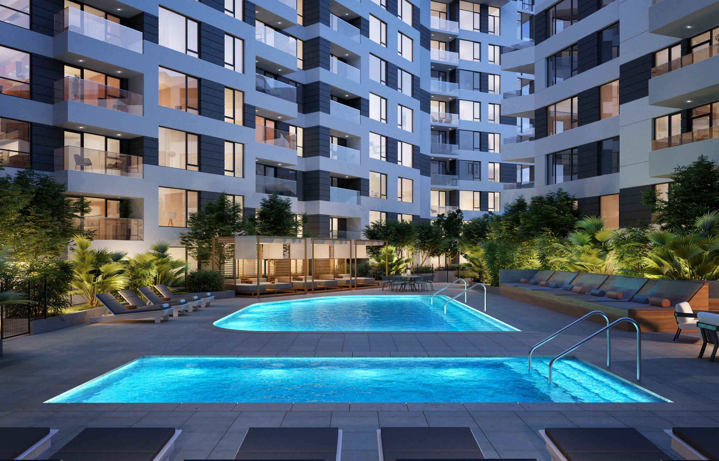 Exterior of pool deck with two pools and lounge chairs surrounded by modern apartment building