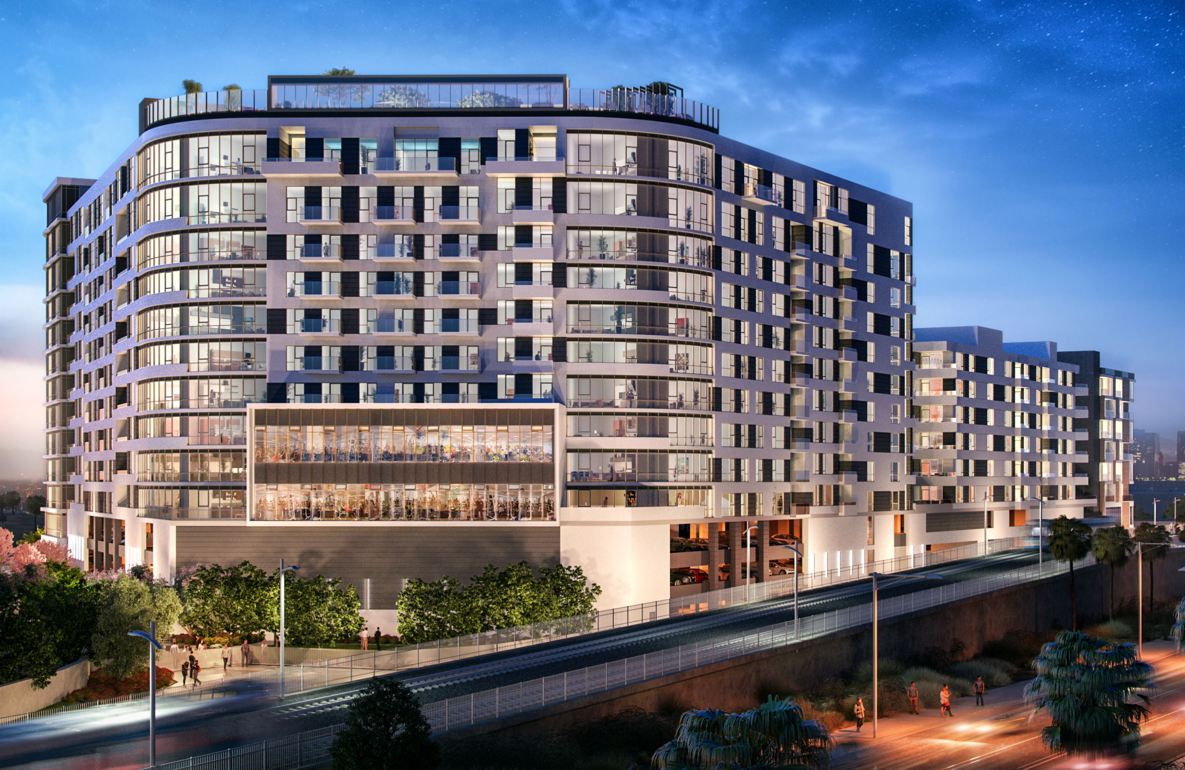 Exterior of apartment building with LA Metro line in foreground