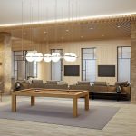 Interior of modern game room with pool table, bar stools, and couches