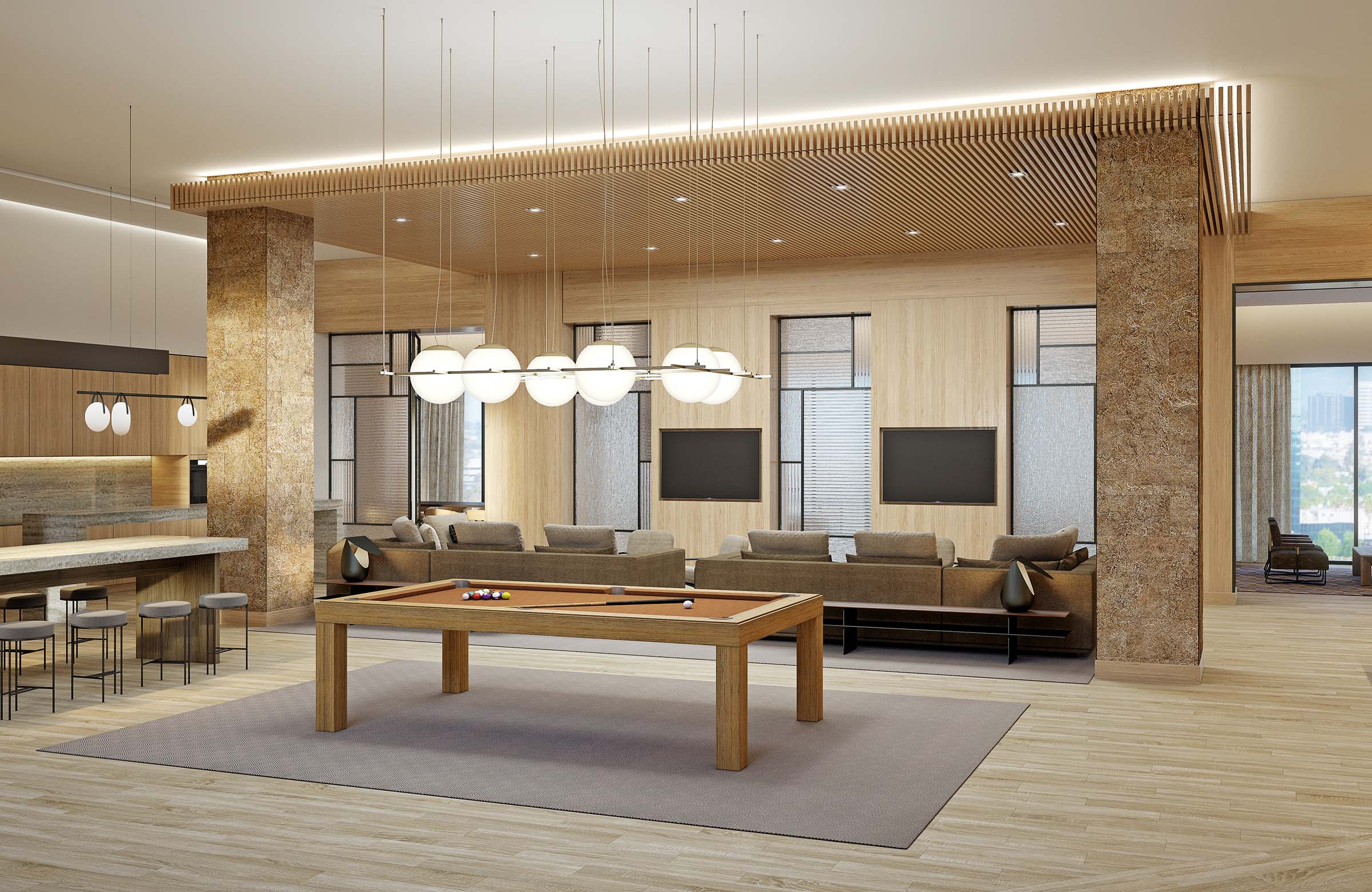 Interior of modern game room with pool table, bar stools, and couches