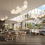 Communal dining area with high ceilings and wall of windows