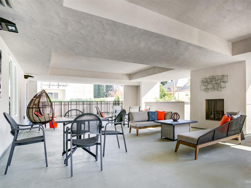 Outdoor patio with modern furniture and fireplace