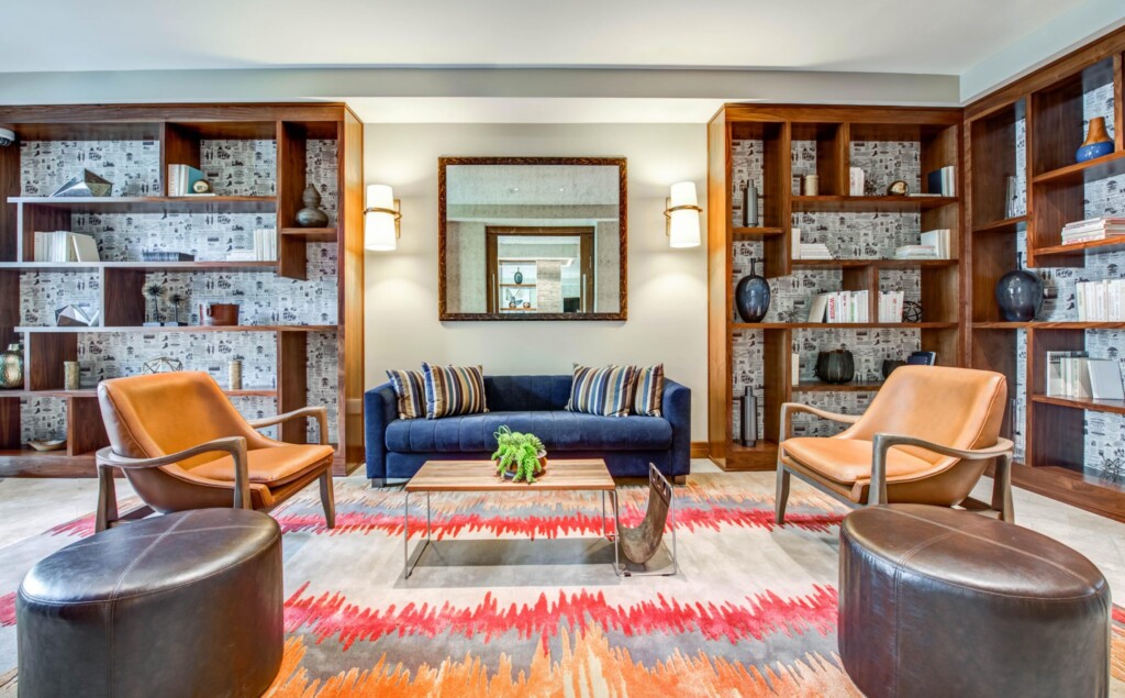 Interior of common area with seating area surrounded by book shelves.