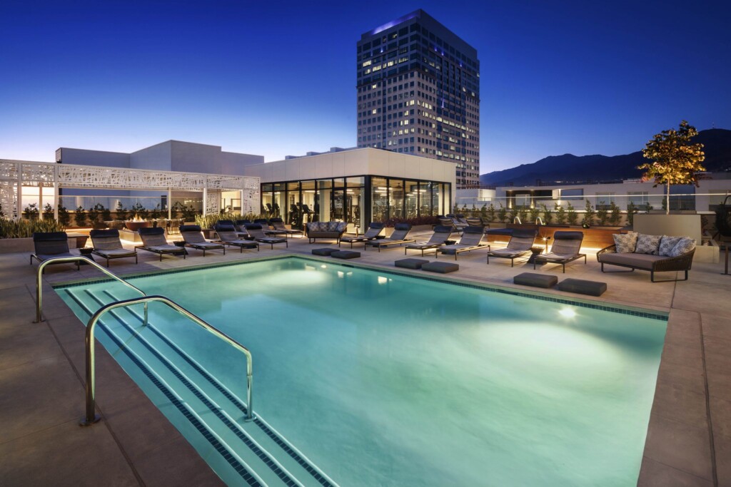 Exterior of pool and deck with couches and lounges.