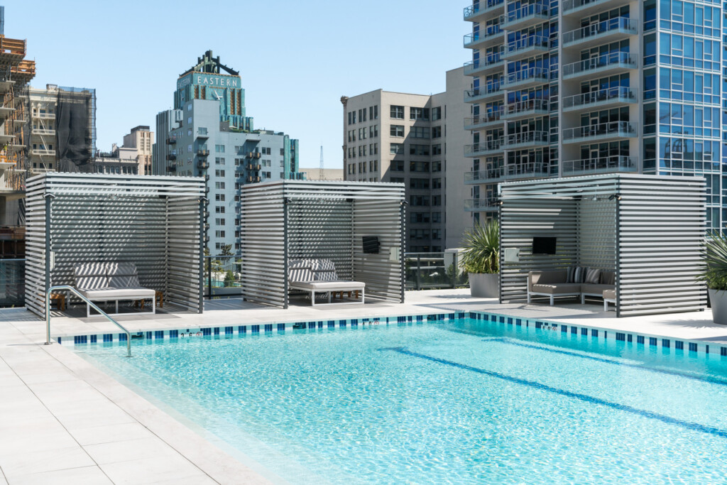 Exterior of rooftop pool with cabanas on pool deck
