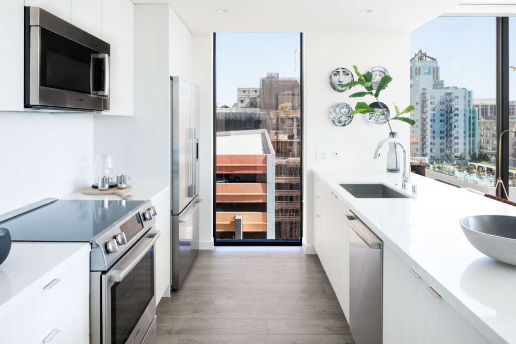 Interior of sleek kitchen with views of downtown LA through windows