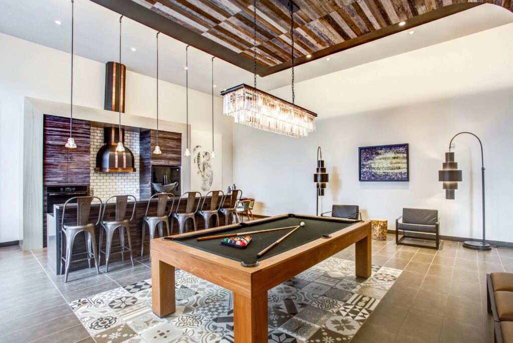 Interior of game room with pool table and bar height seating