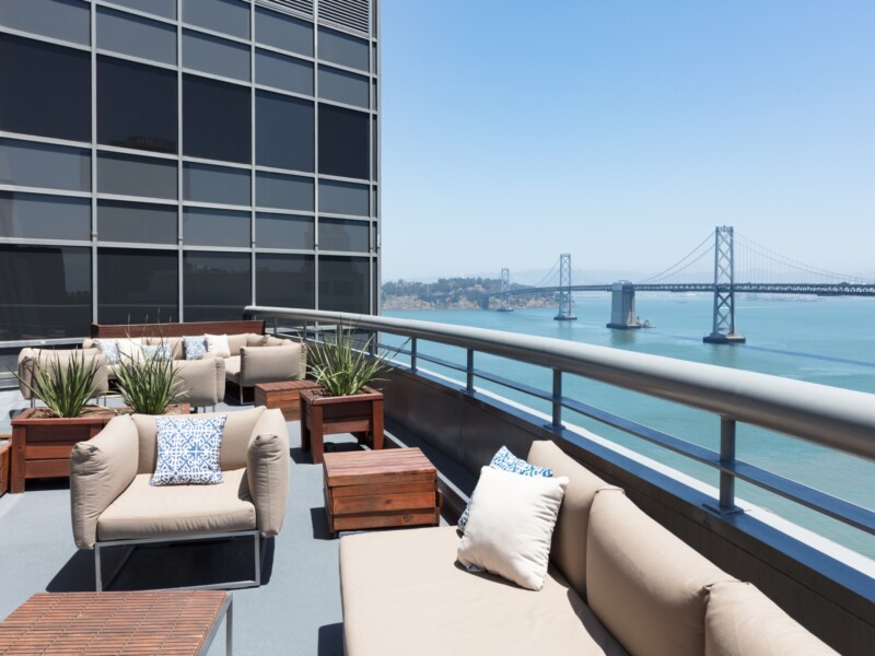Outdoor deck with a view of the San Francisco Bay Bridge.