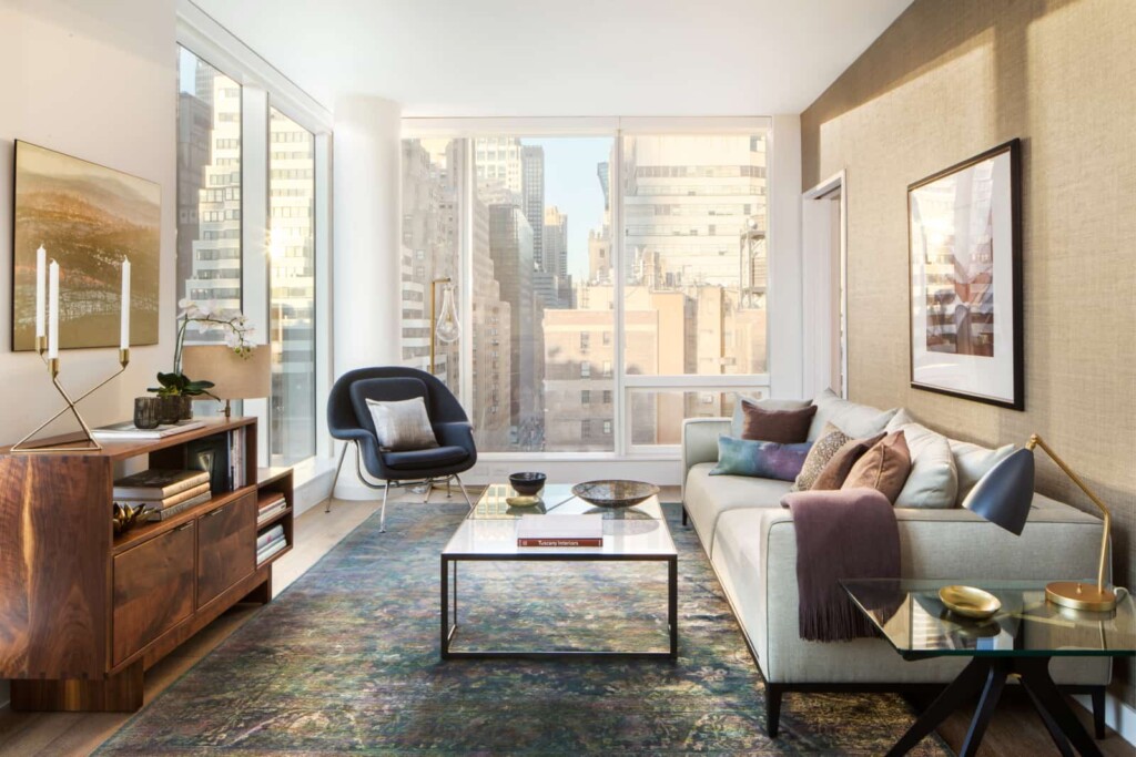 Modern apartment living room with floor-to-ceiling corner of windows with city views