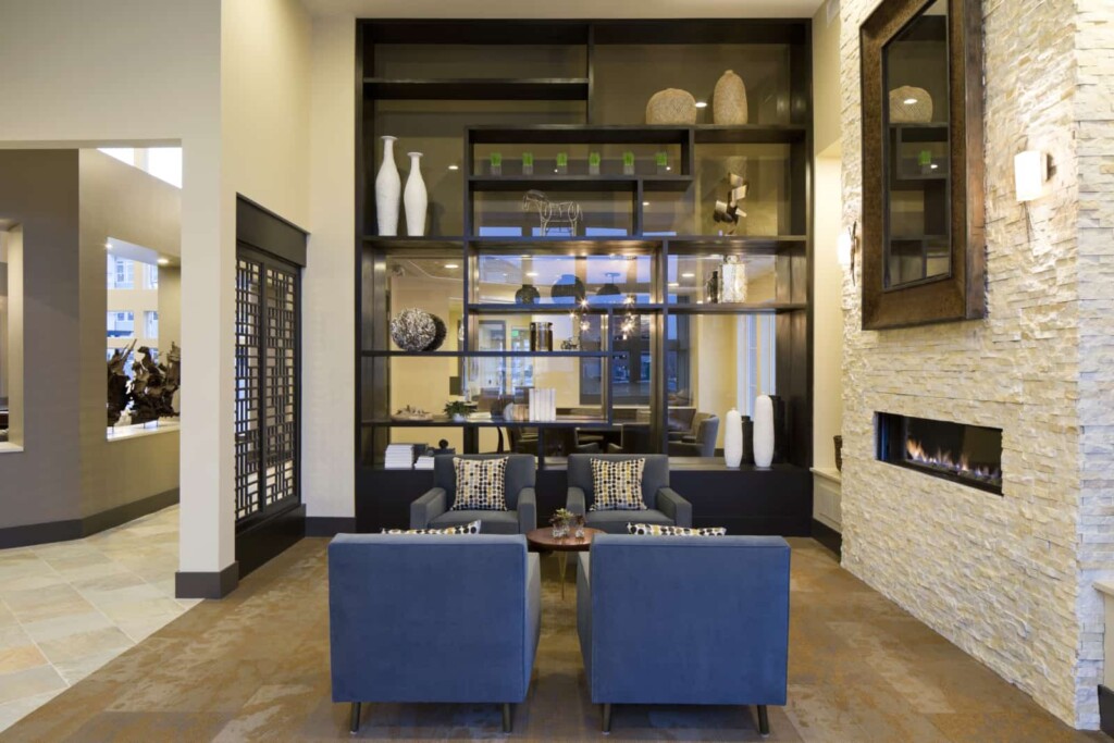 Interior of apartment lobby with modern fireplace and sitting area