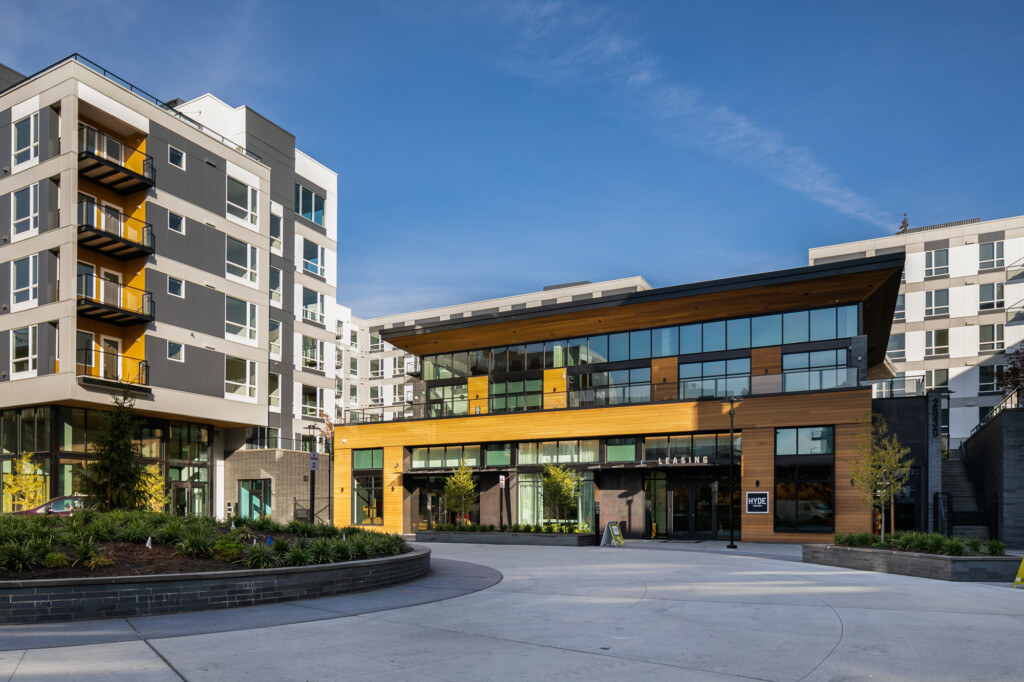 Exterior of modern apartment complex with traffic circle in foreground