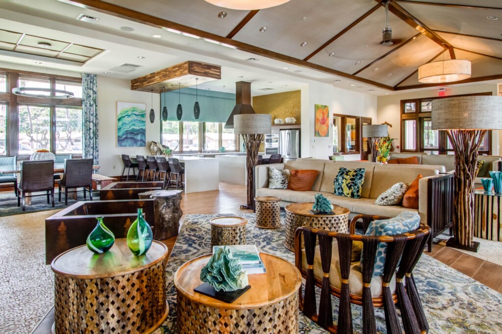 Interior of common area with couches, Polynesian furniture, and kitchen area in background.