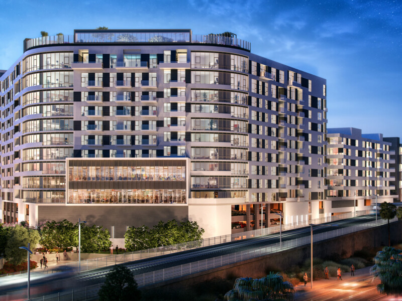 Exterior of apartment building with LA Metro line in foreground
