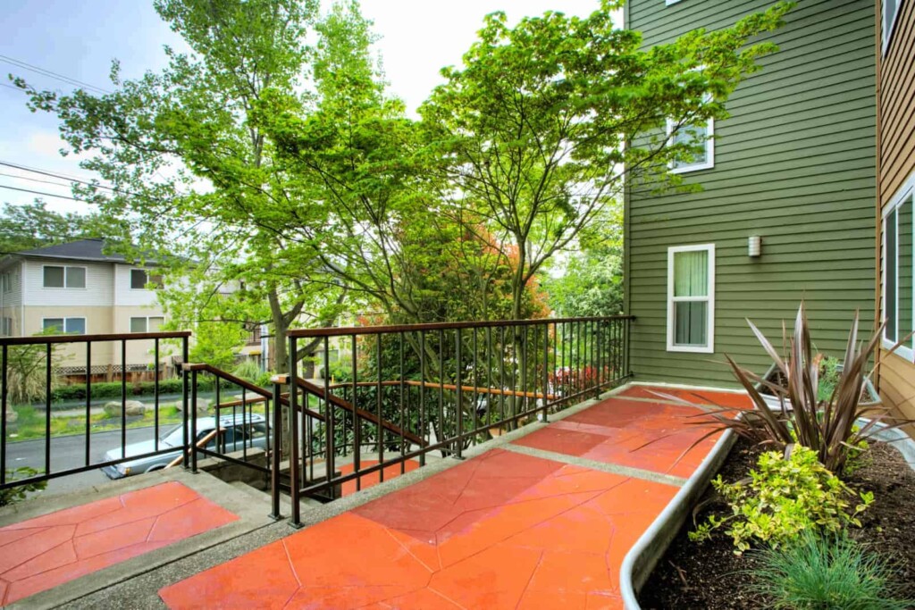 Exterior of staircase and landing with flower containers along the wall.