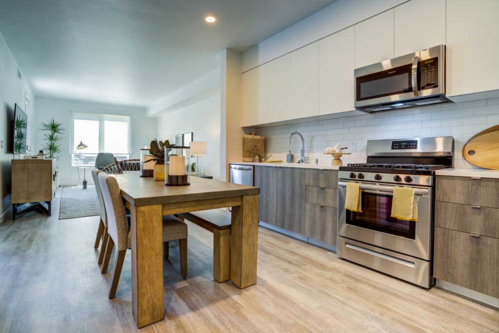 Modern interior of open kitchen, dining table and living room